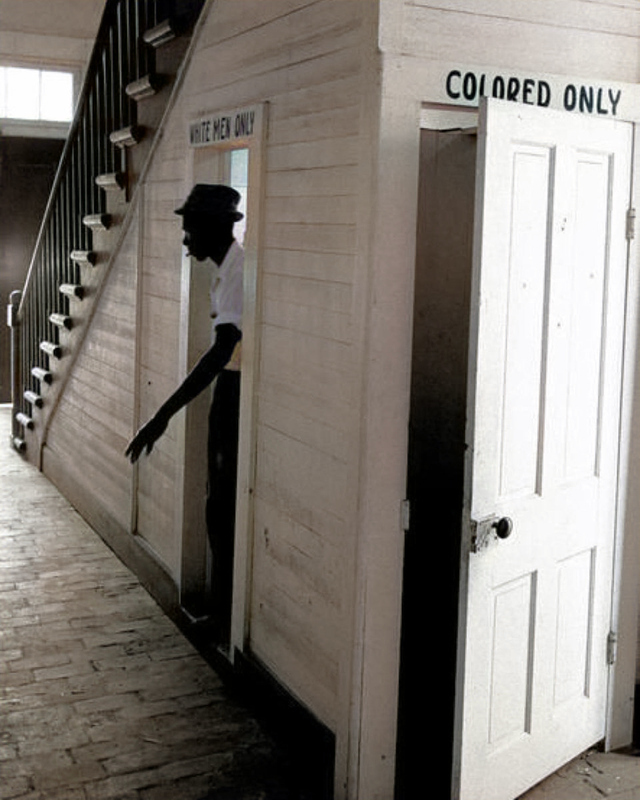 An African American man emerges from using the “White Men Only” bathroom at courthouse in Clinton, Louisiana, 1964.