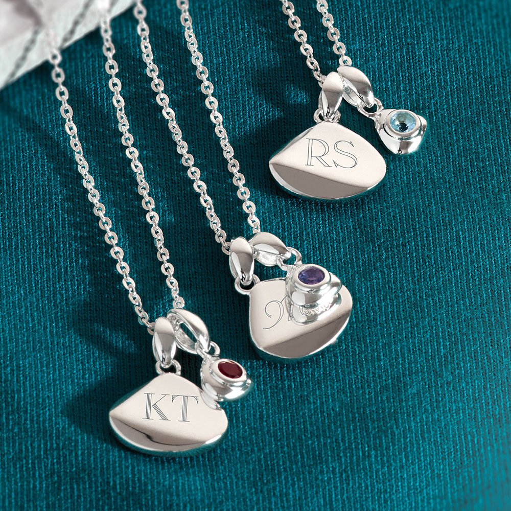 Part of our Coast collection, our January birthstone tag necklace features an organic flat teardrop disc with a mini garnet charm and is made in rhodium-plated sterling silver.