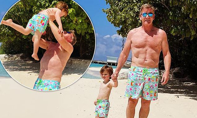 Shirtless Gordon Ramsay, 55, shows off his incredibly buff physique as he larks around with son Oscar, 2, on the beach in the Maldives https://t.co/3F5w8Whiz3 https://t.co/4UdCx0utQE