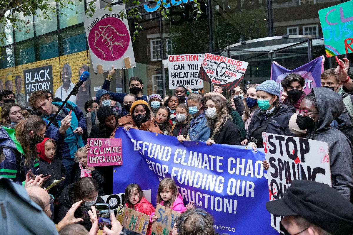 Climate activist Greta Thunberg, center, demonstrates with others in front of the Standard and Chartered Bank during a climate protest in London, England, October 29, 2021, ahead of the 26th UN Climate Change Conference (COP26).