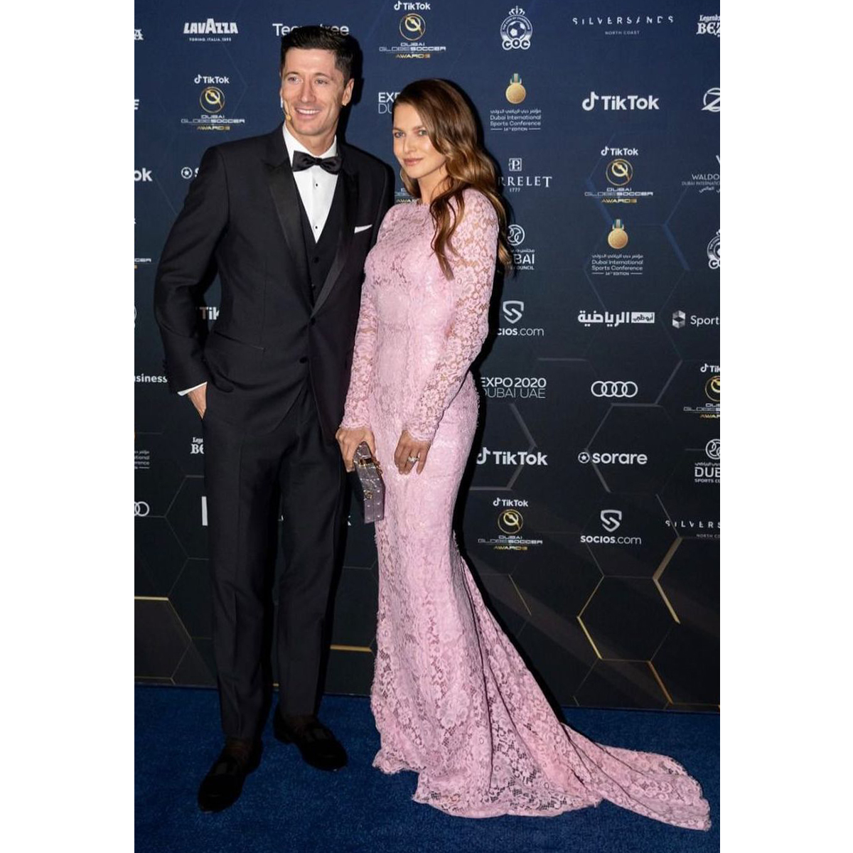 dolcegabbana's tweet photo. @lewy_official received the @Globe_Soccer Maradona Award wearing a Martini-fit three-piece #DolceGabbana tuxedo suit. His wife Anna Lewandowska wore a long lace dress with train, completed with a transparent plexiglass #DGDolceBox.

#DGCelebs https://t.co/EJVIdgnof1