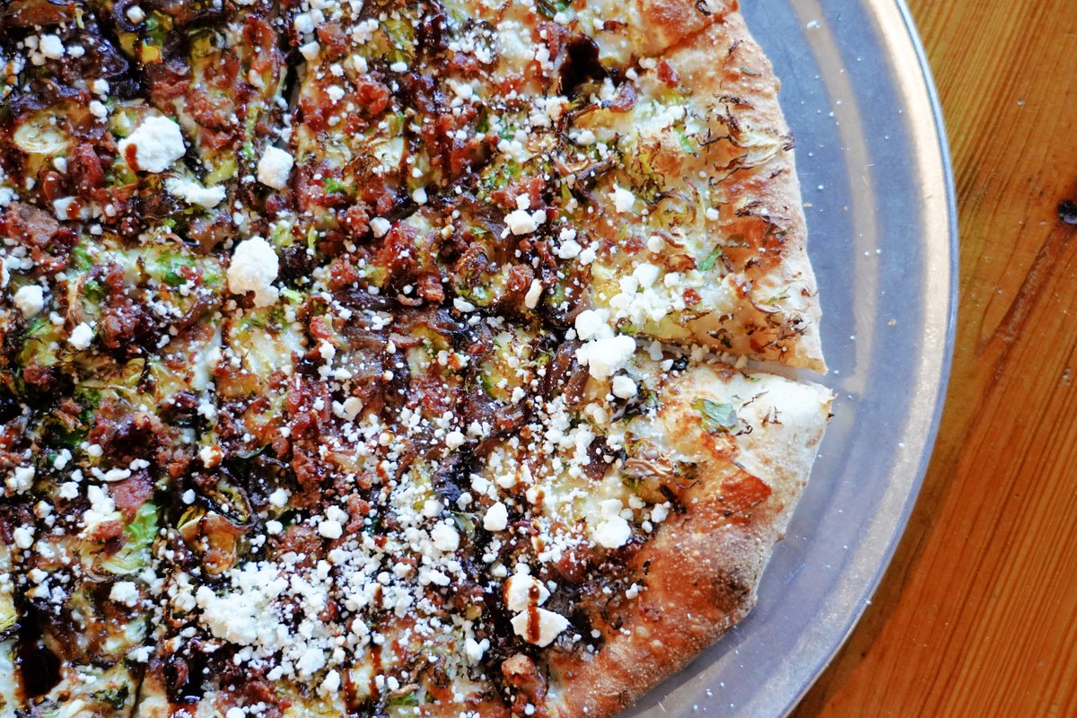 Happy New Year everyone! We're kicking off 2022 with the All A’Sprout It! This delicious "Off The Map" pizza is topped with crème fraîche, our house cheese blend, roasted Brussels sprouts, caramelized onions, savory bacon, goat cheese, and a balsamic reduction.