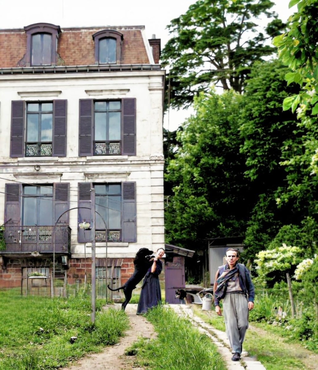 Louis-Ferdinand Céline in front of his Second Empire house in Meudon with, in the background, his wife Lucette Almanzor playing with one of their dogs, June 5, 1957.
François Pages photography for Paris Match.