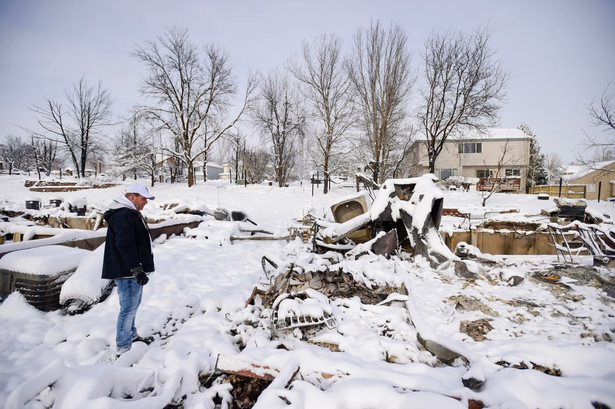 It's an impossible image to comprehend: The still smoking remains of homes destroyed by a raging wildfire... covered in snow bit.ly/3ELeOKl via <a href="/photojmatthew/">Matthew Jonas</a> #MarshallFire #cowx