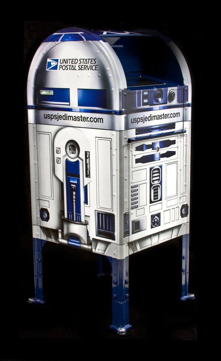 A photo of the R2-D2 mailbox against a black backdrop.