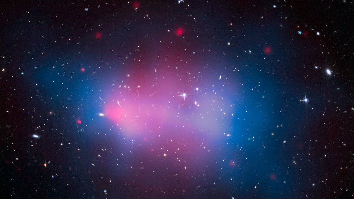 This is a composite image of X-ray and optical light with dark matter (derived mass) mapped out in blue. Because dark matter doesn't emit any radiation, astronomers instead precisely measure how its gravity warps the images of far background galaxies like a funhouse mirror. This allows them to come up with a mass estimate for the cluster. Chandra's X-ray data are shown in pink and these have been overlaid on optical data from Hubble that shows the individual galaxies in the cluster as well as stars in the field of view.