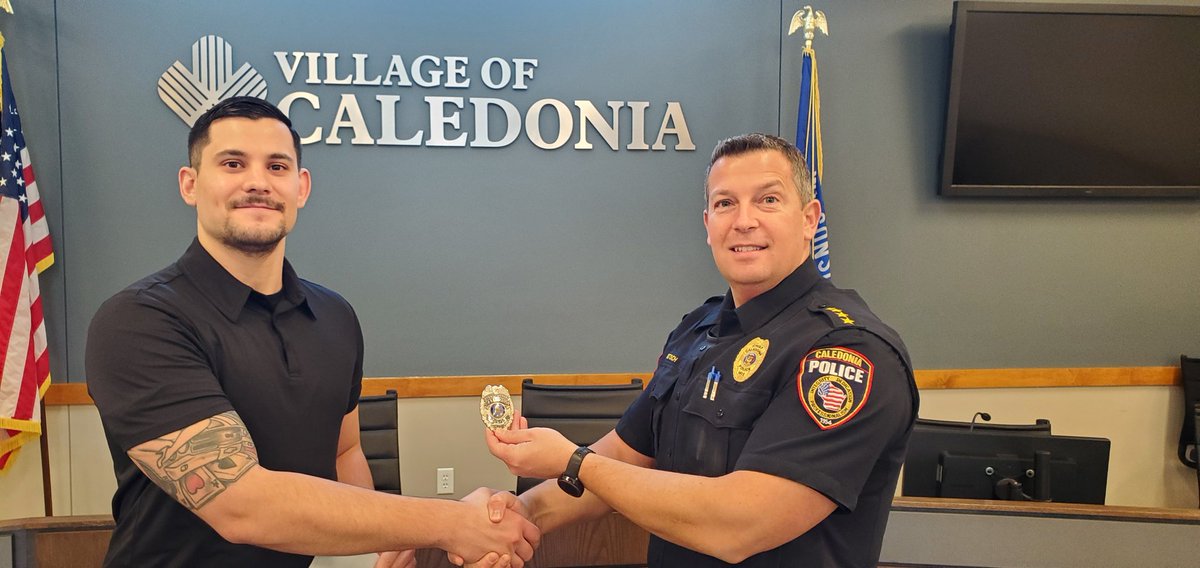 Officer Austin Sherifi is given his badge by Chief Botsch after being sworn in this morning.