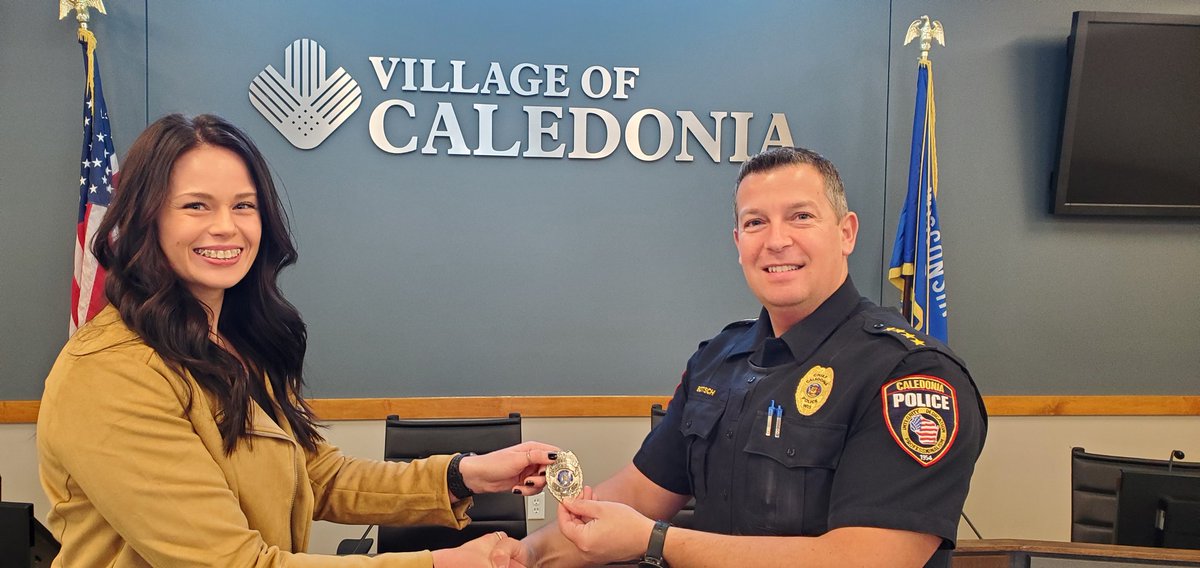 Officer Sarah Hanley is given her badge by Chief Botsch after being sworn in this morning. 
#welcometothevillage
#rookie