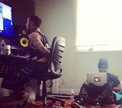Mac and Travis in a bedroom studio.