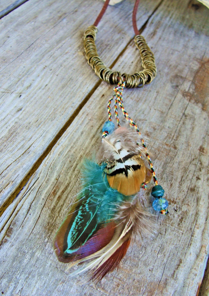Teal & Gold Feather Pendant on Brown Suede Necklace w Antique Gold Rings: etsy.com/listing/736429… #feathernecklace #tealfeathers #goldfeathers #brownsuedenecklace #featherjewelry  #antiquegoldrings #facetedbeads  #adjustable #Boho #hippie #NativeAmerican #giftforher #etsyhandmade