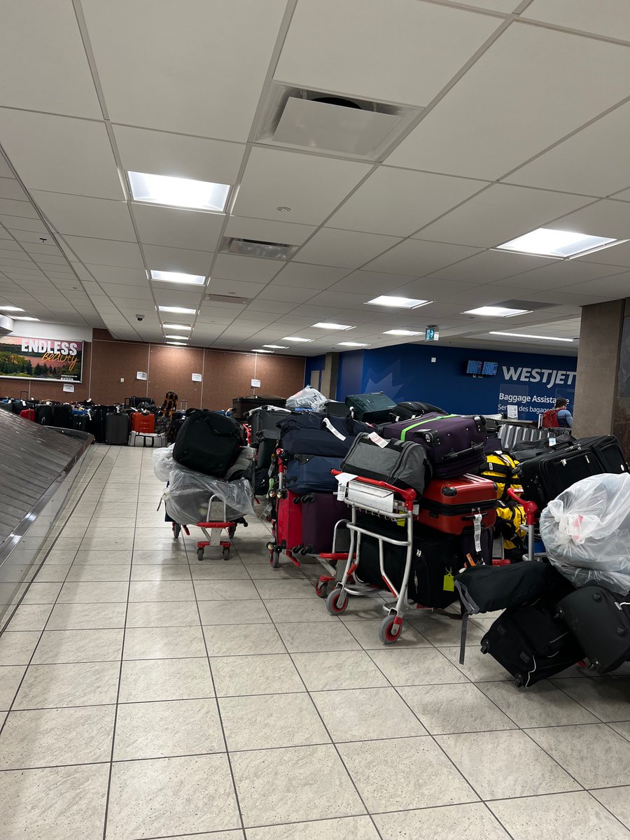 caparici76's tweet photo. @WestJet Here’s the view for 2022 at Calgary Airport. Hundreds of luggage being held by you. We arrived to Saskatoon on Sunday without our luggage. I want my luggage and you are holding it hostage. Who does that?  We supported you and went on trip @WestJet respond https://t.co/LXhVdjDAqP