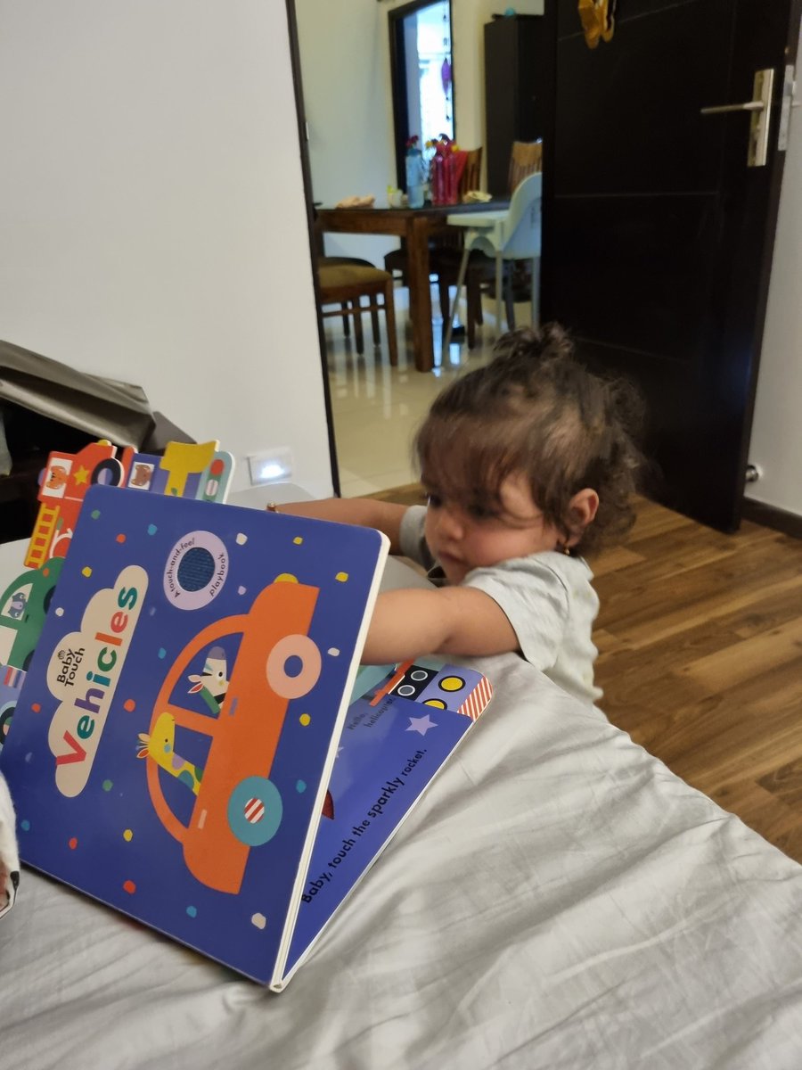 This little one is obsessedddd with her books ..