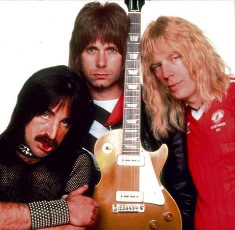 Genelle's tweet photo. I feel like the designer of the new Rush pinball machine might have based the illustration of Alex Lifeson on this picture of Michael McKean in This is Spinal Tap. https://t.co/Gtyfu1pifz