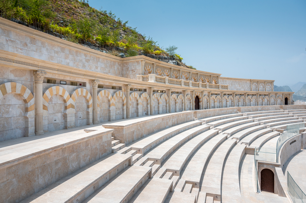 unec_co's tweet photo. The semicircular structure has a stone facade includes 234 arches and 295 columns and is situated on an elevated hillock. Khorfakkan Amphitheatre - a prominent addition to the cultural landmarks in the emirate of Sharjah. https://t.co/fYAIifgt87