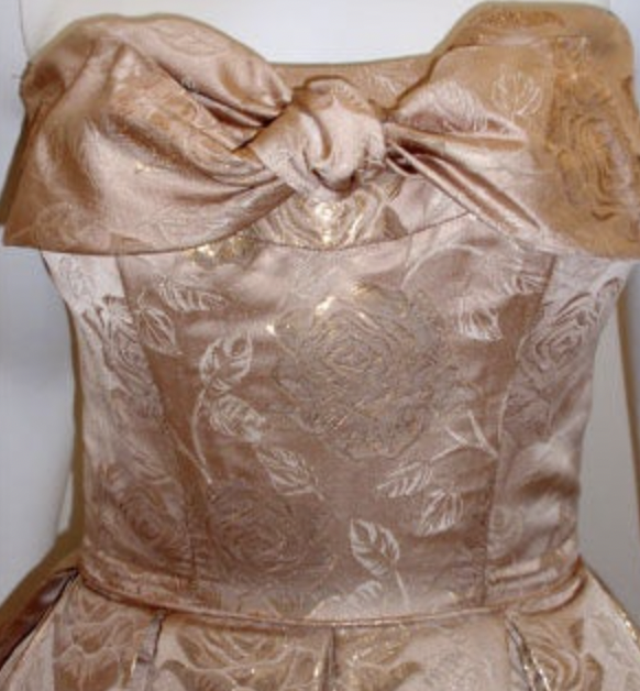 LaurenCDeutsch's tweet photo. Today's #ootd is this 1950s Don Loper strapless evening gown. It's made of what I think is metallic gold brocade and features a lovely bow on the bodice. We actually have the measurements for this one, it's 34 in bust, 26 in waist, and 39 in hips. #1stbids #fashionhistory https://t.co/VQDyUXyLJG