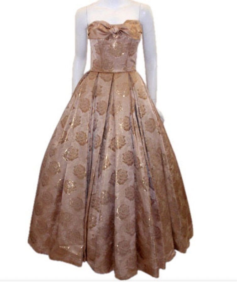 LaurenCDeutsch's tweet photo. Today's #ootd is this 1950s Don Loper strapless evening gown. It's made of what I think is metallic gold brocade and features a lovely bow on the bodice. We actually have the measurements for this one, it's 34 in bust, 26 in waist, and 39 in hips. #1stbids #fashionhistory https://t.co/VQDyUXyLJG