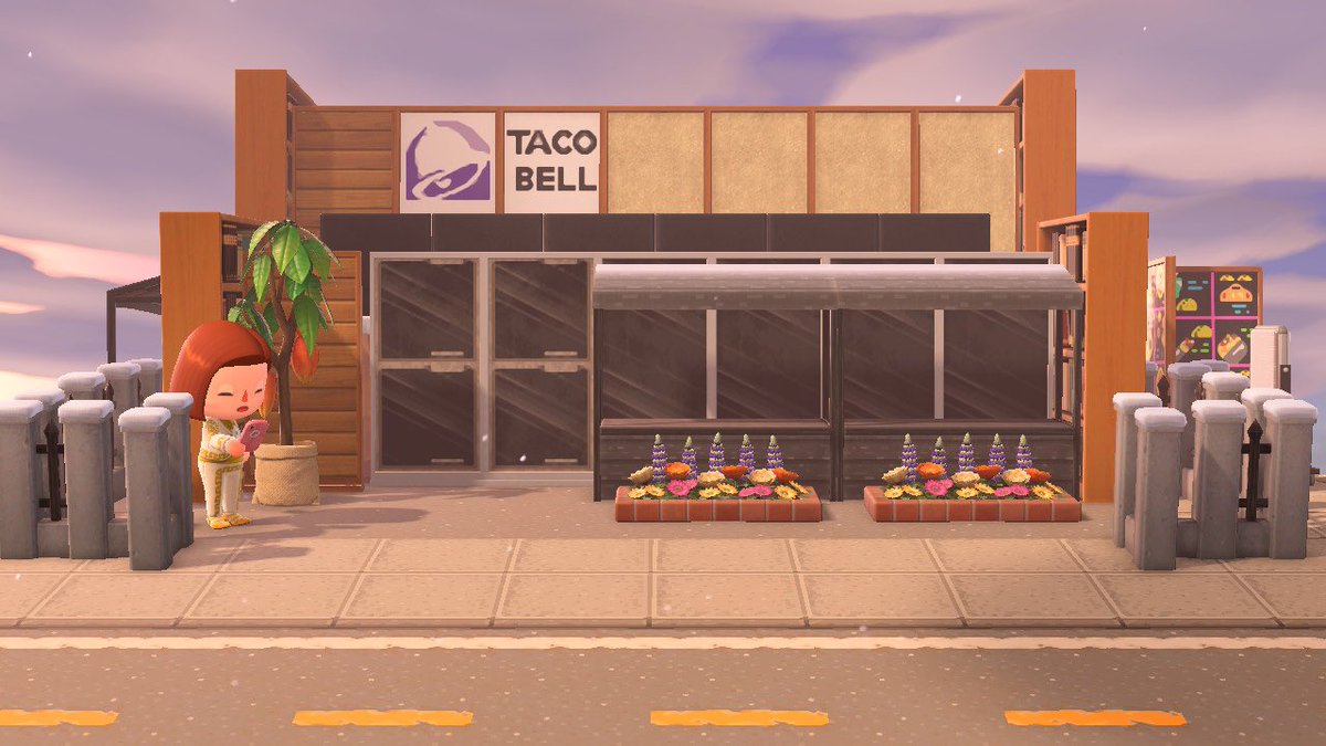 Screenshot of animal crossing with an exterior of a Taco Bell restaurant on a city street