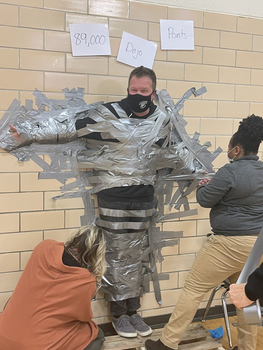 OPSMTSSB's tweet photo. @HollyMurphy_OPS got to witness @OPS_Kennedy’s students celebrate meeting their semester 1 Dojo point goals by duct taping Mr. Carlson to a wall. Positive reinforcement helps behavior expectations “stick.” #ethicofcare #mtssb #classdojo https://t.co/qQeJdrRcSc