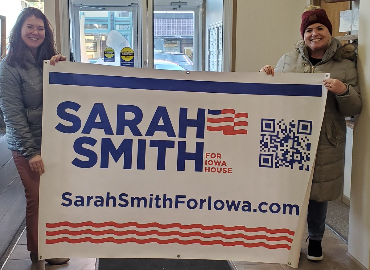 SarahSmith4Iowa's tweet photo. On this cold day, it was heart warming to see my new look for the 2022 campaign on a banner. Thank you Double You Marketing! 🇺🇲 #sarahsmithforiowa https://t.co/CtArJecwr2