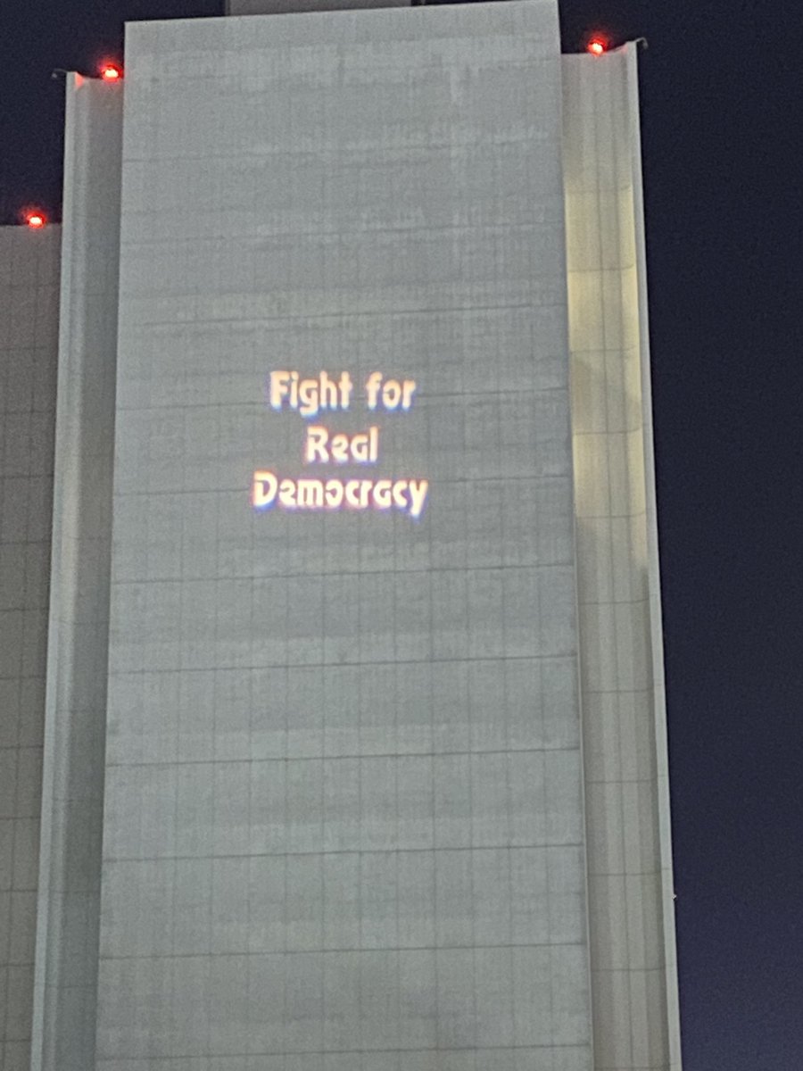 Analisa_Swan's tweet photo. Attending a powerful vigil for democracy, #January6th remembrance, &amp; day of action! Thank you to great activists speaking tonight @manashooshtari &amp; Heidi Hu w/@GrassrootsDemHQ, @HansPJohnson pres. of @EAPDLA, Armando Olivas w/@LALabor! #LightUpDemocracy #ONEV1 #DemVoice1 #wtpBlue https://t.co/UyU70yshWz