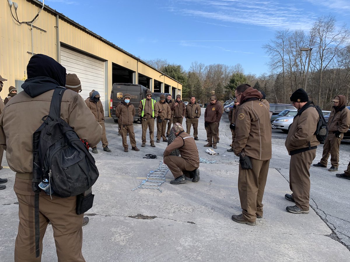Stroudsburg Safety Committee members performing a snow chain demo in preparation for the coming snow.