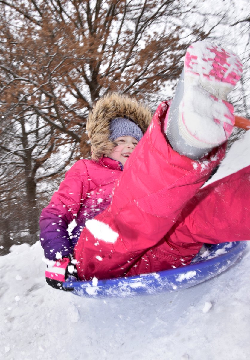 7-year old Maria Lazarev enjoys sliding down a makeshift hill left by a plow in her hometown of Westfield, Ma. on Friday, January 7, 2022.  Western Mass. got several inches of snow during the Friday morning storm.
