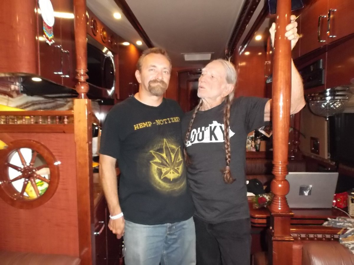 NecroTourist's tweet photo. Since Willie Nelson is trending, here's Willie and I on the bus, before the show in Louisville, in 2014. 
Can you guess what we were doing?

#WillieNelson #Hempnotized #WilliesBus https://t.co/63U32ULrZC