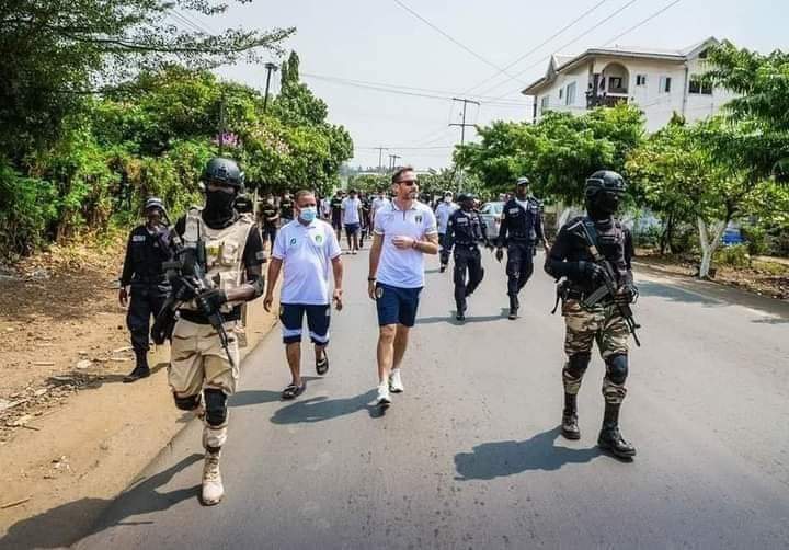 MarkBareta's tweet photo. Mauritania team in the city of Victoria #Ambazonia. Footballers are shielded by la Republique du Cameroun  Military officers. The picture is as clear as our message, #Ambazonia is a war zone. Those who have ears should ear. Don't fall a victim. @CAF_Online @ArreyMcNtui @BBCSport https://t.co/QxP18SYTEy