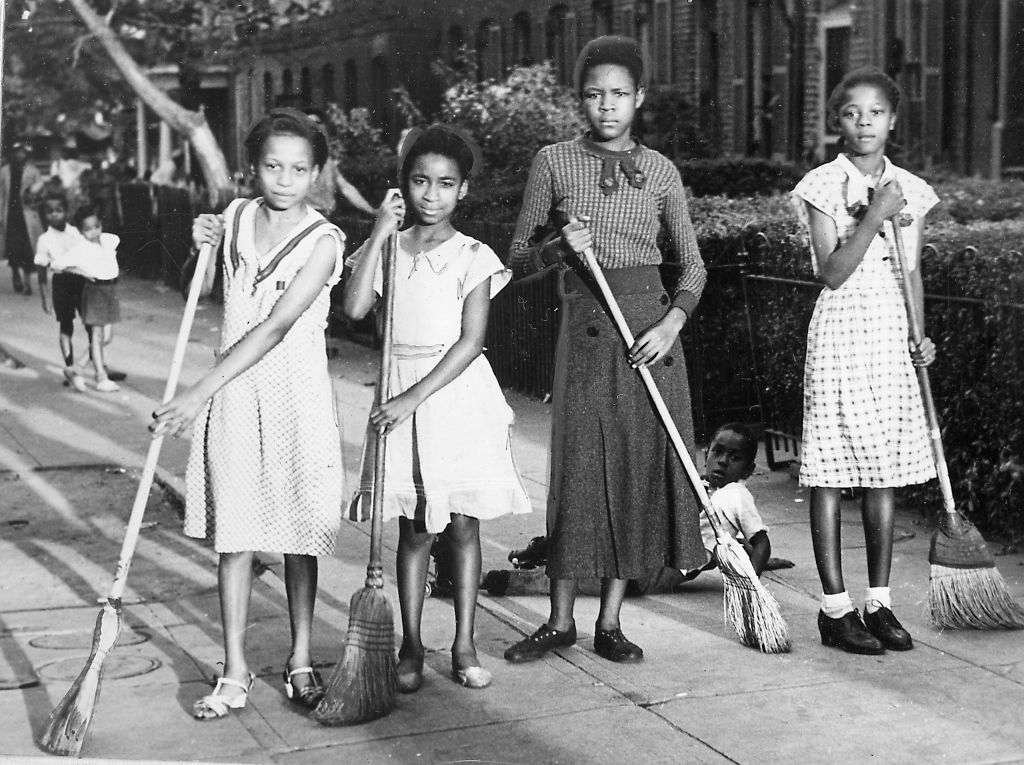 Young girls clean up their block, somewhere in Baltimore, Maryland (1935)
