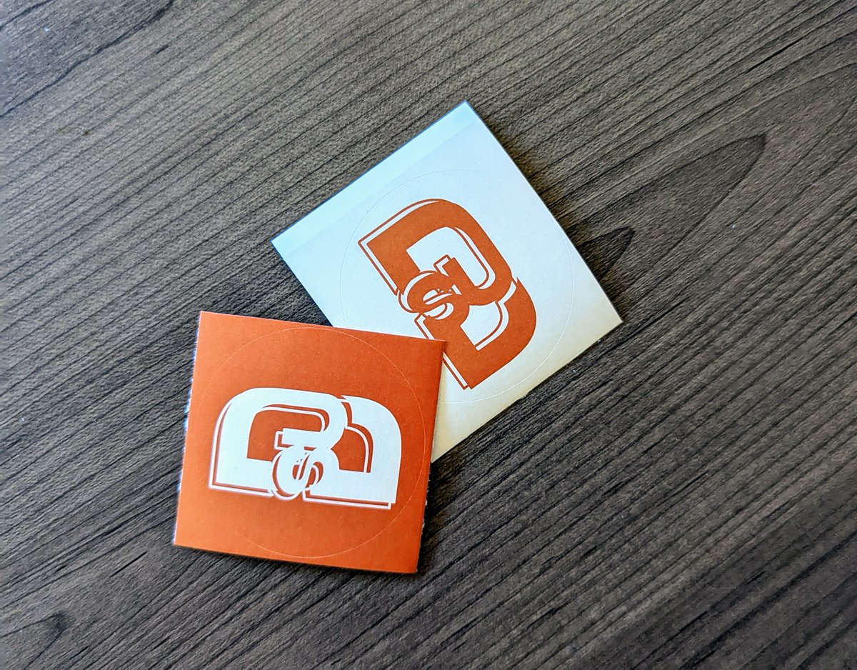 New merch just dropped! See us around this semester and get your hands on a shiny, new DSU sticker. 🧡🤍

IMAGE DESCRIPTION: A photo of two DSU stickers on a wooden surface. One sticker is orange with a cream DSU logo on it and the other is cream with the logo in orange.