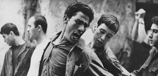 DHPatWM's tweet image. A screen capture from the film “The Battle of Algiers” (1966). This film was based off of Saadi Yacef’s memoire. Yacef was a leader of the National Liberation Front (FLN) and drew attention towards the anti-colonial efforts in French Algeria.