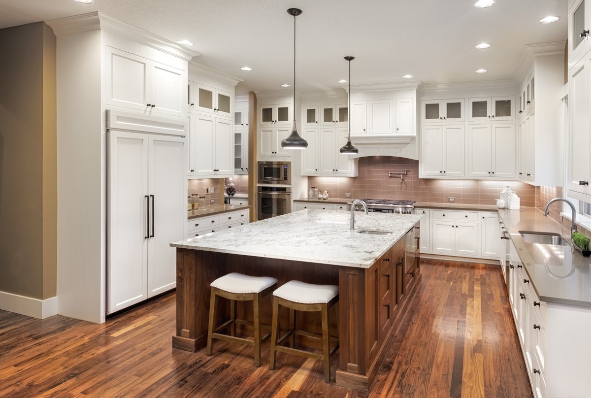 Crisp white cabinets to the ceiling with black hardware, and a stunning granite island top creates an equal parts earthy stylish/equal parts bright and inviting feel in this space. 

Looking for some other white and wood ideas? Look no further...

ow.ly/sV0X50HqpPk