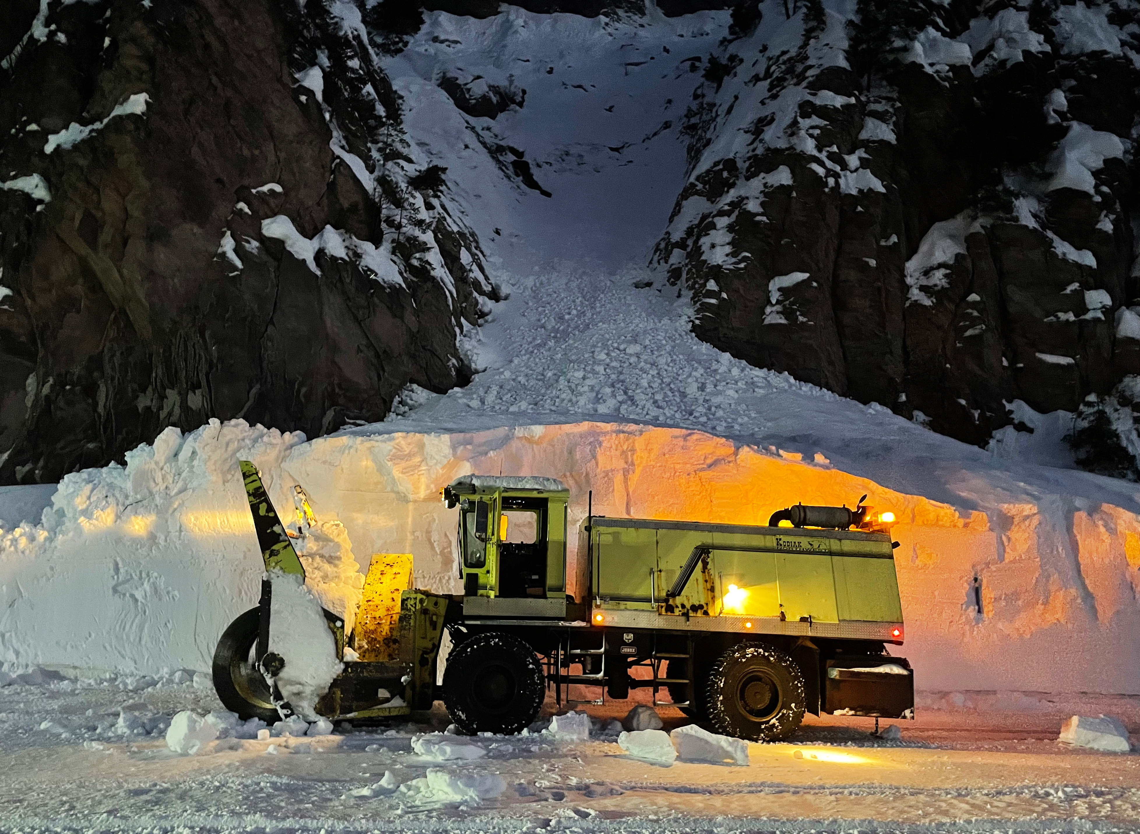 Crews use a grader to cut back the more than 11 feet of snow along US 12 over White Pass.