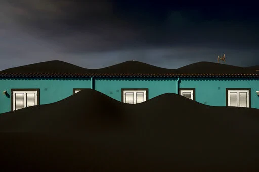 This image of a home covered in ash from a volcano erupting on the Canary island of La Palma, Spain, on Nov. 1, 2021, will be available as an NFT on AP’s NFT marketplace. (AP Photo/Emilio Morenatti)