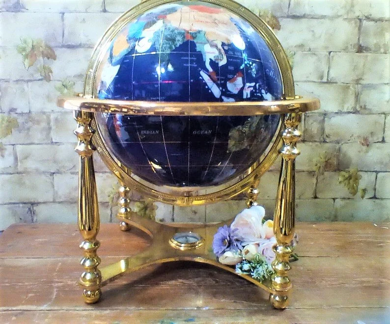 This is an unusual Blue Lapis world globe because it uses over a dozen natural gemstones to make the countries and continents. It's in a brass stand with a compass at the bottom. Very pretty. #worldglobe #gemstones #bluelapis #globeinstant #vintageglobe