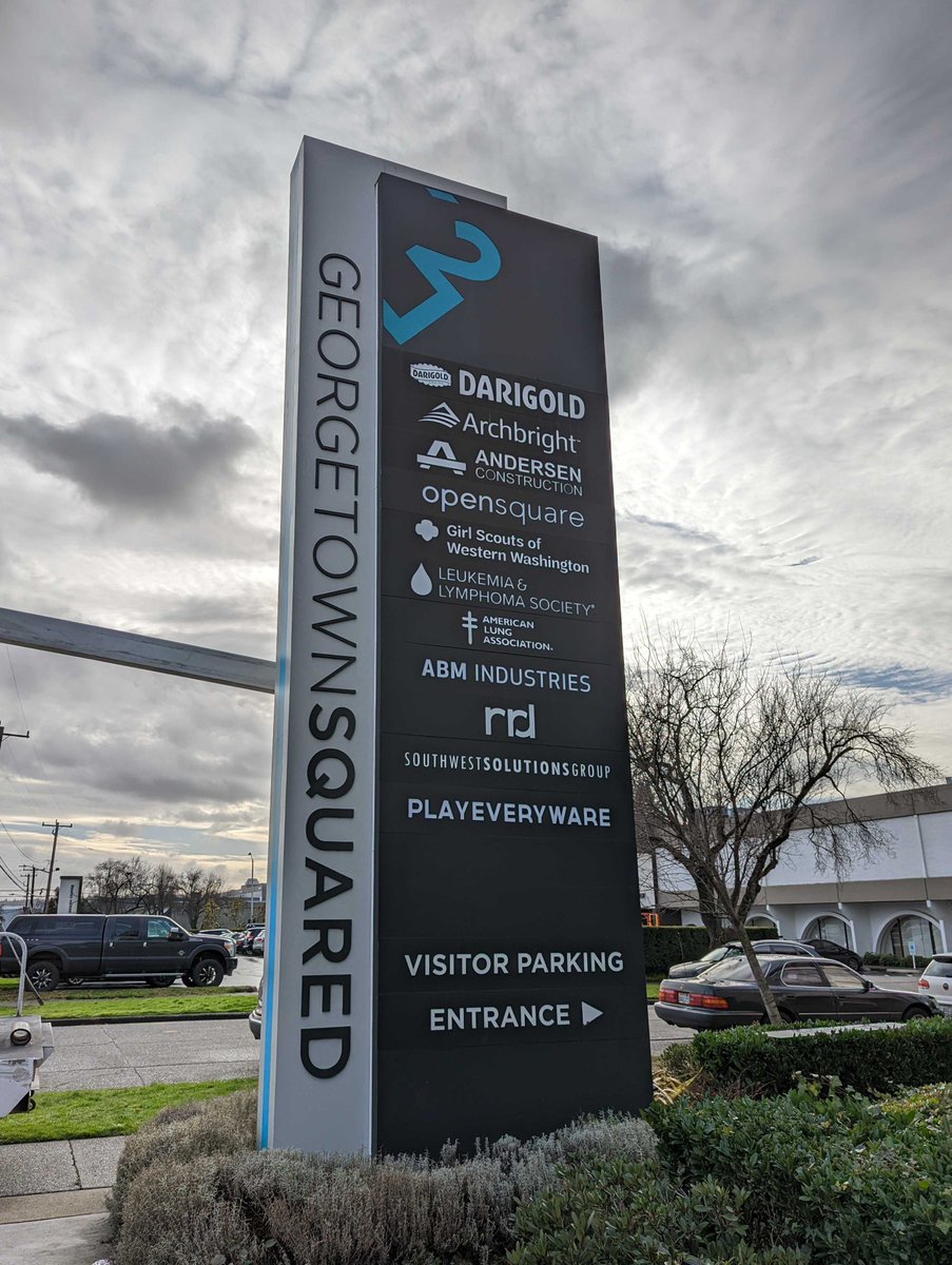 A picture of the Georgetown Squared office building monument signage featuring the newly added sign for PlayEveryWare