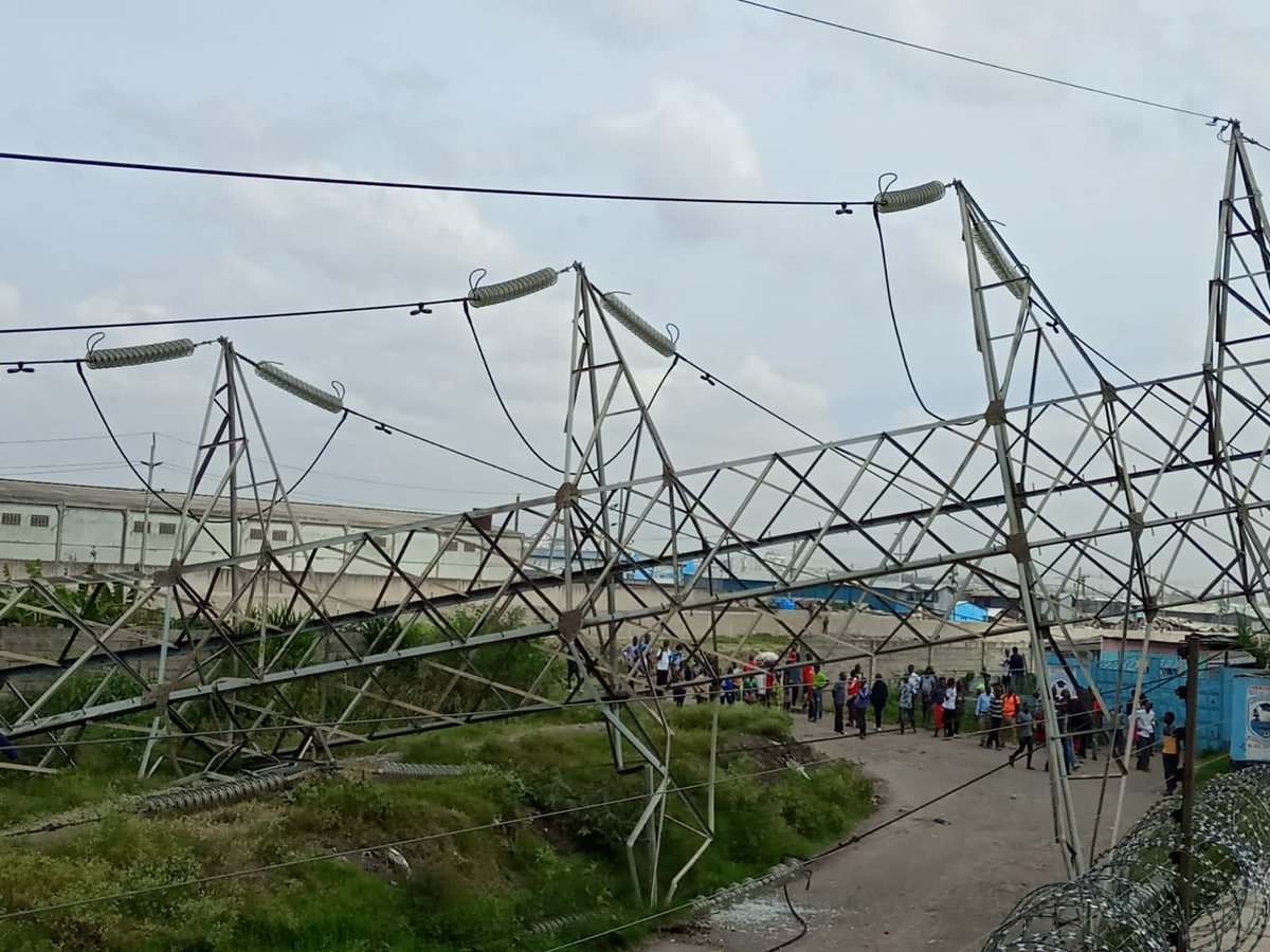 JamalGaddafi's tweet photo. Kenya Power High Voltage transmission towers have collapsed in Mukuru near Imara Daima Railway station in Embakasi South along Mombasa road. This is the cause of the blackout. KPLC engineers are already there undertaking repairs. Seems like the blackout will take longer. https://t.co/yQzyKdDbBp