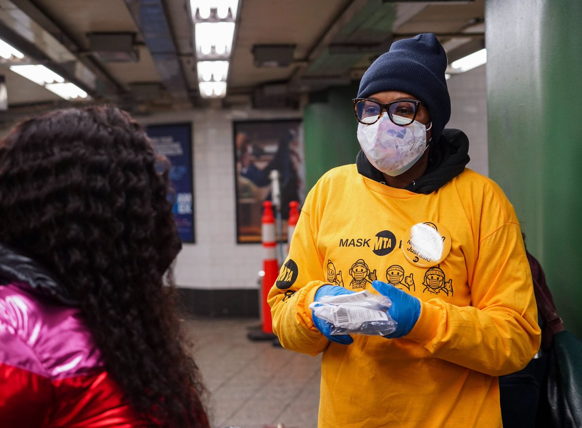 A volunteer offering a free mask at the Atlantic Av-Barclays Ctr subway station.