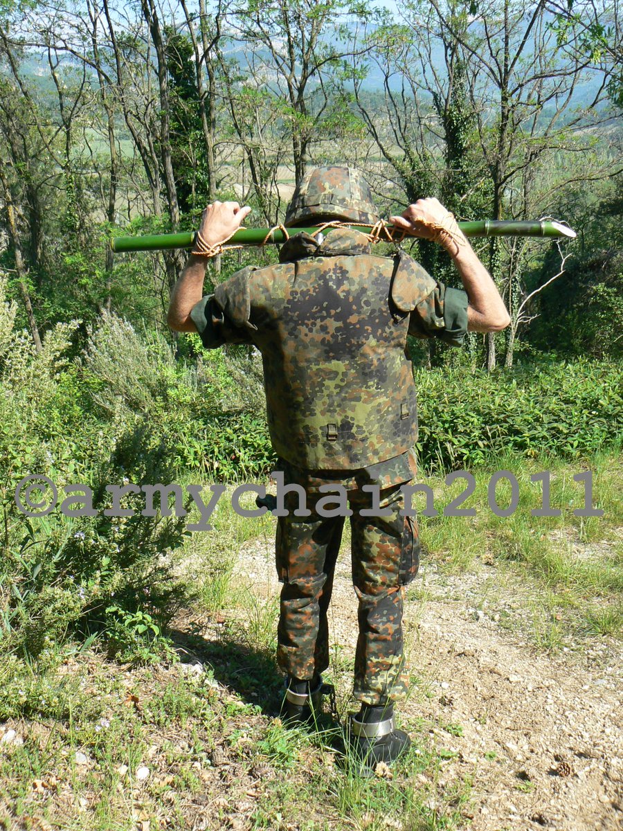 armychain's tweet photo. Bound to a bamboopole. The roped wrists render the pw helpless and the extrem heavy bootshakles are good for hard movement outdoors. Shuffle on prisoner i have not the whole day time for interrogation. Sir yes Sir. https://t.co/FAlPvdnYWt