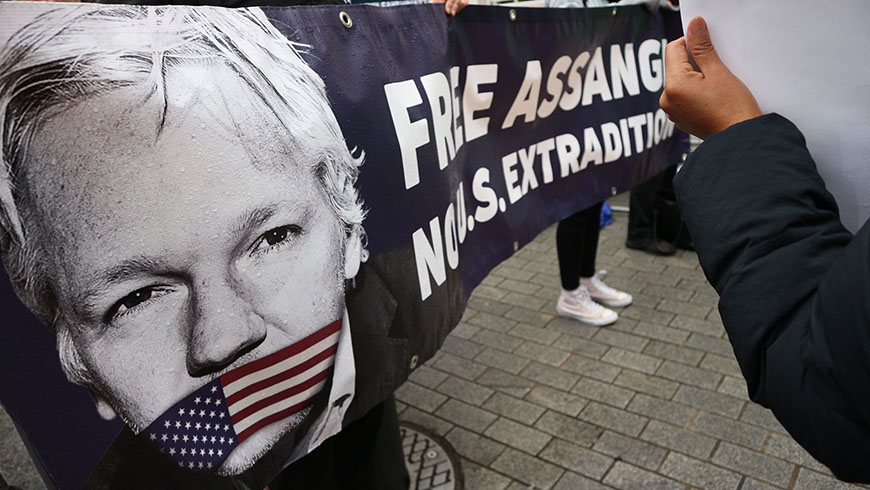 FREE ASSANGE protest banner.