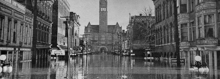 85 years ago today, this was the scene on Third St in Parkersburg WV during the #1937flood. The county courthouse and city building were cut off by the water, and the mayor banned alcohol sales because the jail was inaccessible.