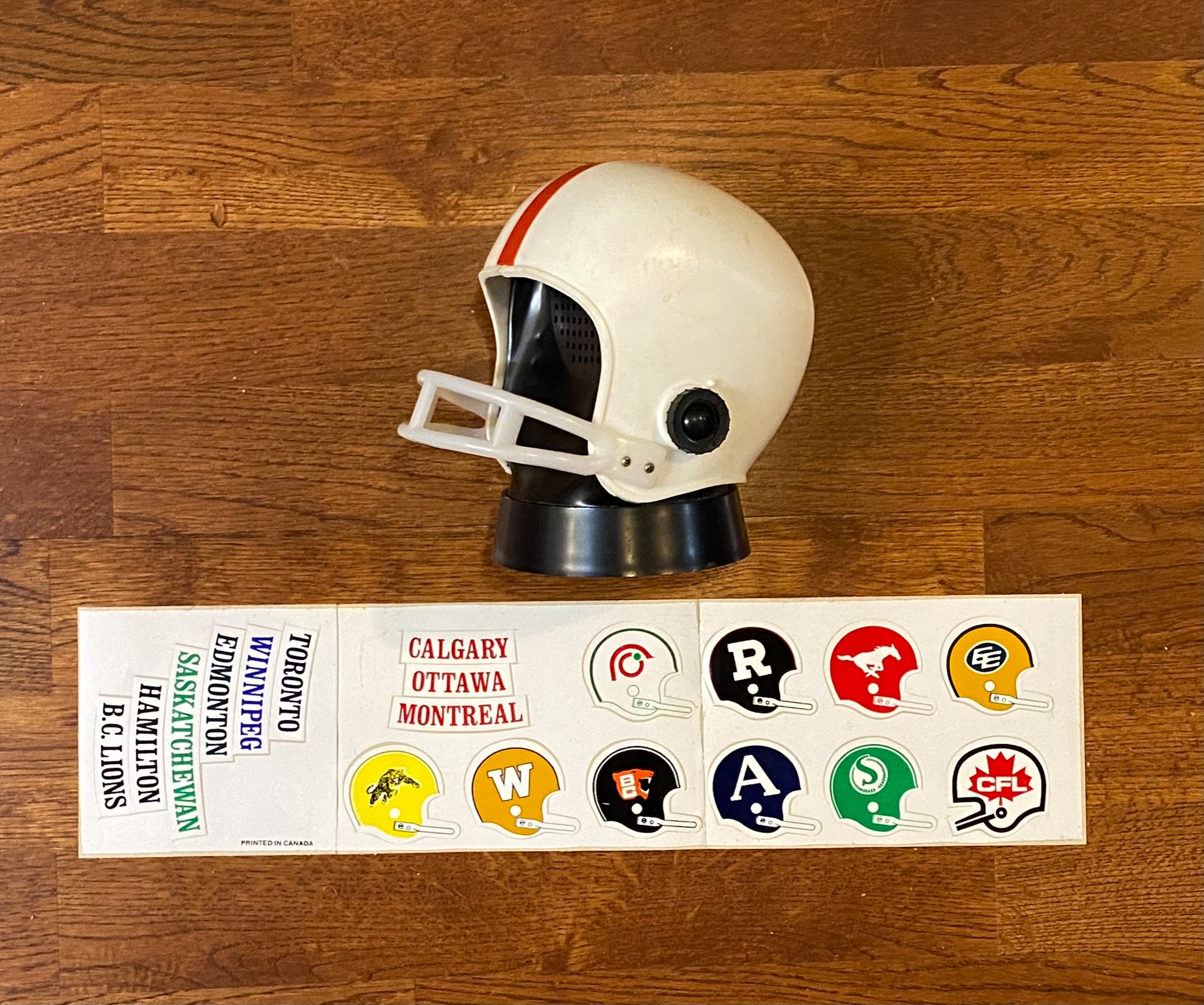 Daryl Slade on Twitter: "Here I have an early 1970s football helmet radio  with sheet of stickers of each of the 9 CFL teams' helmet logos and city  names, plus the original