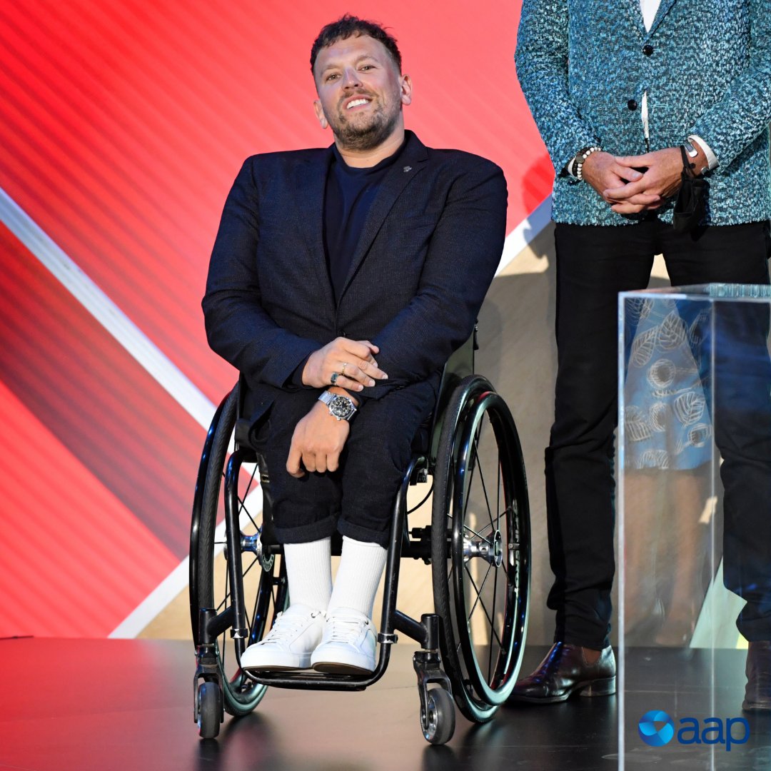 AAPNewswire's tweet photo. Dylan Alcott is the 2022 Australian of the Year!

The wheelchair tennis champion is the first person with a disability to be named #AusOfTheYear in the award's 62-year history.

Alcott took out the honour hours after cruising to another #AusOpen final.

📷 | Mick Tsikas - AAP https://t.co/R5XYcxY9EX
