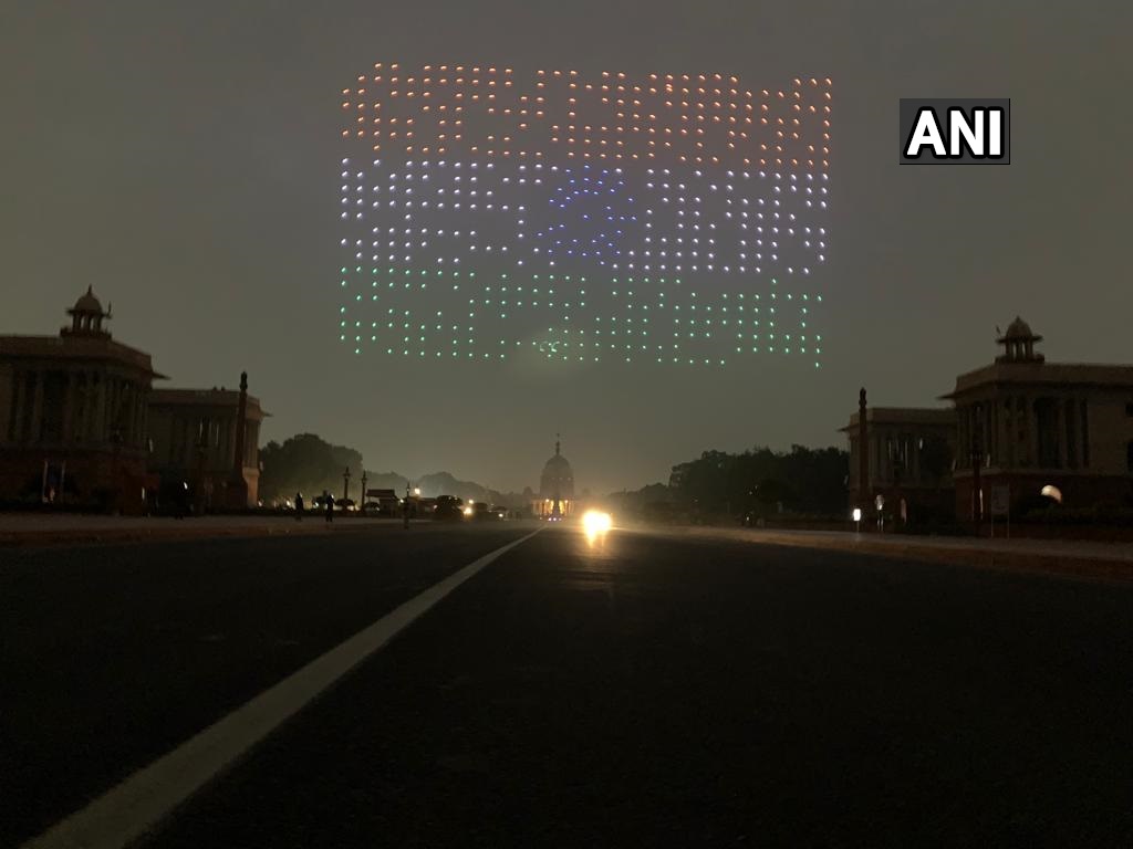 ANI's tweet photo. Delhi: On the eve of #RepublicDay2022, 1000 Made in India drones make different formations as a part rehearsal for the Beating Retreat ceremony, at Vijay Chowk https://t.co/68SIwR6VjA