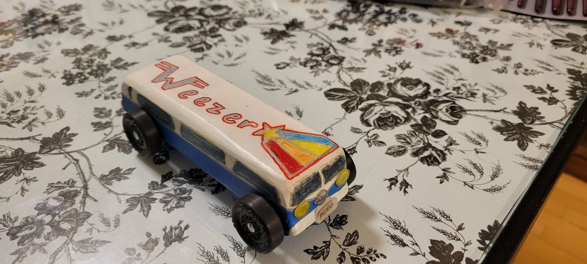 TRubelee's tweet photo. Hey @Weezer, y'all are my daughter's favorite band and she wanted to design her Cub Scout Pinewood Derby Car inspired by the new album Van Weezer!  Hero and Undone are some of her favorite songs too!  Check out the VW logo, it might look familiar! #CubScouts #PinewoodDerby https://t.co/opPjWB3vUs