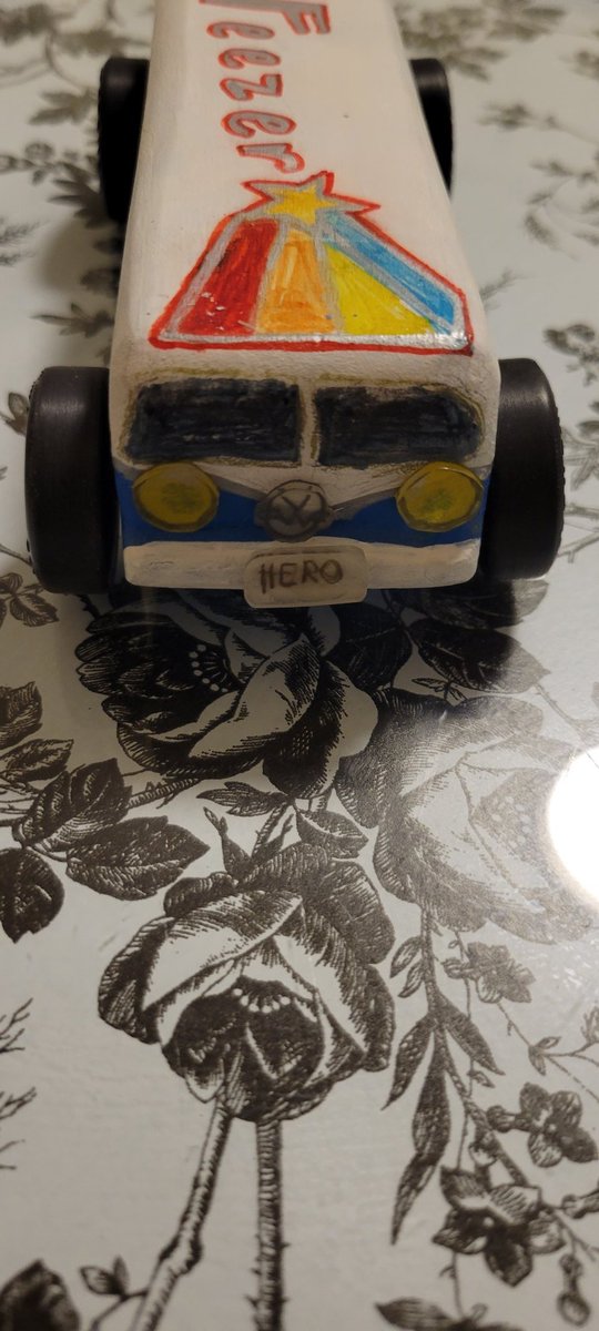 TRubelee's tweet photo. Hey @Weezer, y'all are my daughter's favorite band and she wanted to design her Cub Scout Pinewood Derby Car inspired by the new album Van Weezer!  Hero and Undone are some of her favorite songs too!  Check out the VW logo, it might look familiar! #CubScouts #PinewoodDerby https://t.co/opPjWB3vUs