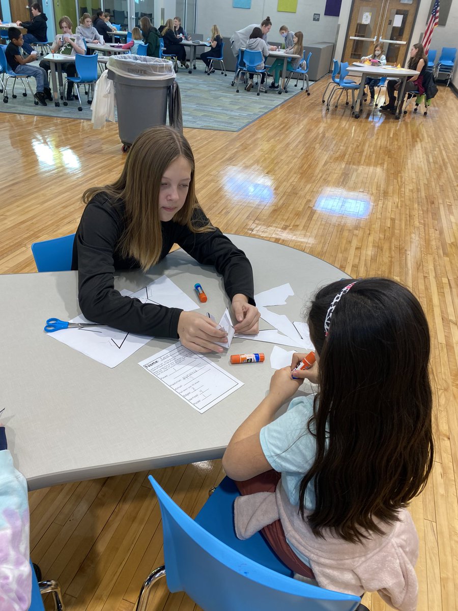 doerhoefer_j's tweet photo. Middle school students mentoring second graders!  Using nets to create 3D shapes.  Love the relationship building! #goodhueschool https://t.co/jUJolThr0s