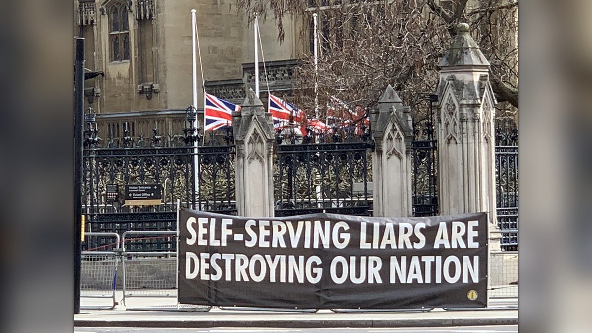 snb19692's tweet image. This picture was taken on April 14th 2021 - The flags at half mast as Prince Philip had died on 9th April. So whilst the flags were at half mast at Parliament - Downing Street were partying??? The banner has since been stolen by the Metropolitan Police!