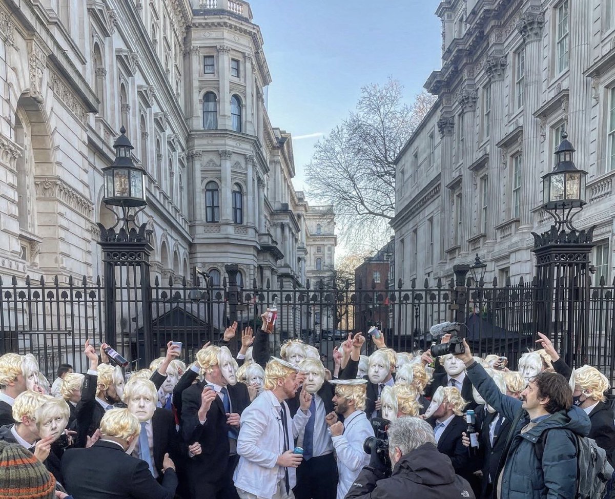 Hundreds of people are throwing a party, dressed as Boris Johnson outside Downing Street chanting “my name is Boris and this is a work event” 🤯