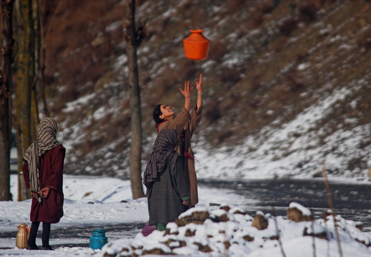 A girl play with pot in the Daksum area of Kashmir, 107 km south of Srinagar. <a href="/umeerasif/">Umer Asif</a> #archive